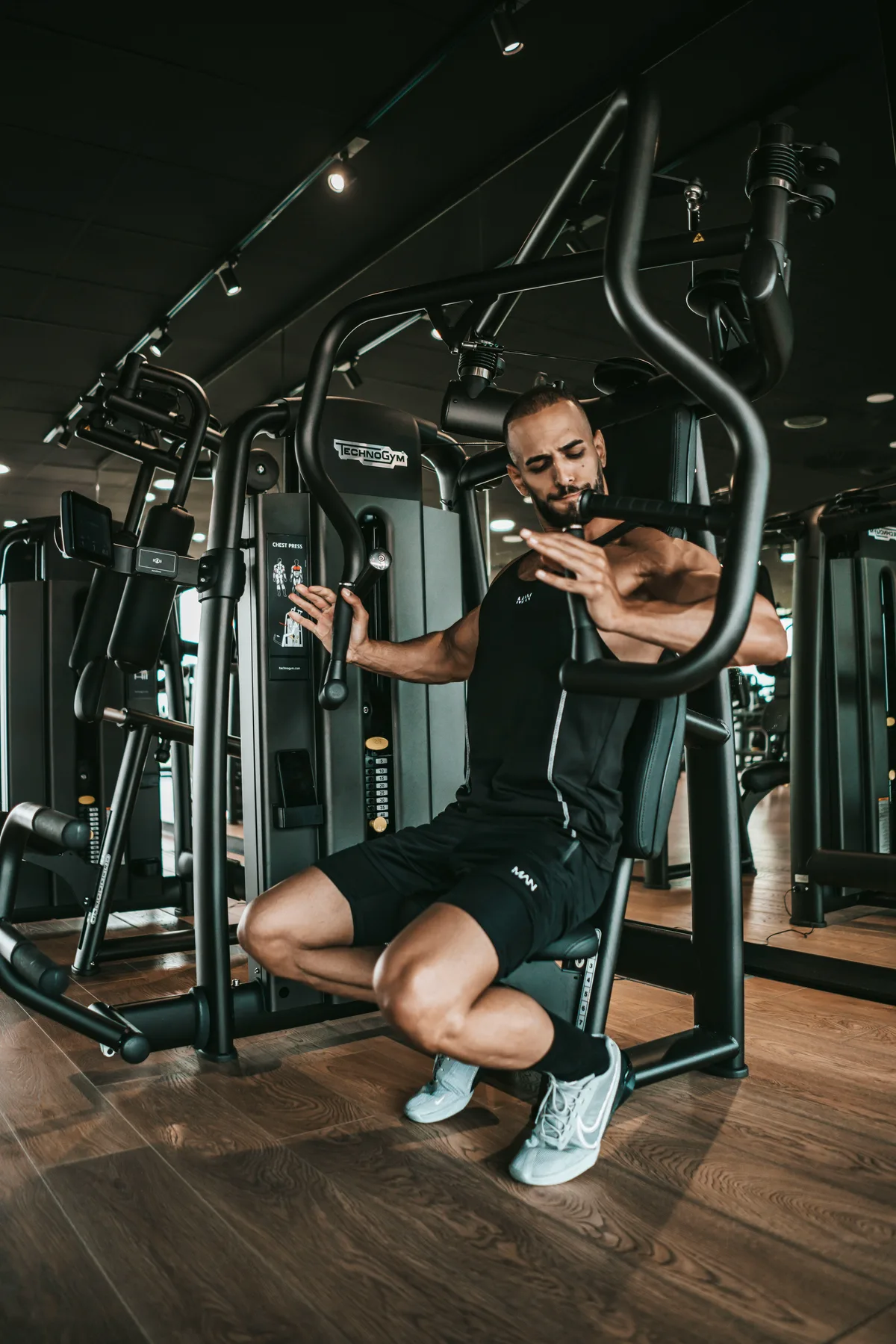 Athlete sitting in a gym between training sets to rest and recover