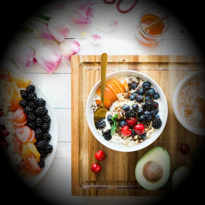 Healthy breakfast flat lay with fruit, yogurt, avocado and coffee