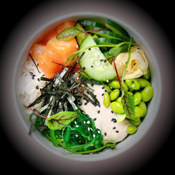 Salmon poke bowl with rice, edamame and vegetables